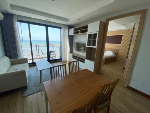 Spacious living room with ocean view and access to balcony