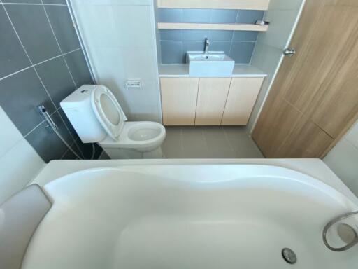 Modern bathroom with bathtub and wooden vanity