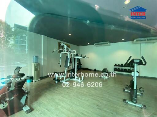Modern home gym with large mirrors and various exercise equipment