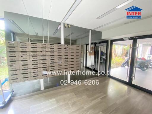 Modern building lobby with large mailbox installation and glass doors