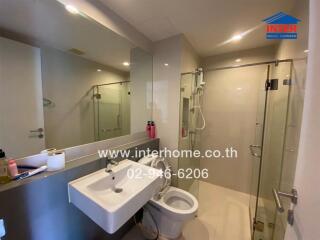 Modern bathroom interior with glass shower and mirrored vanity