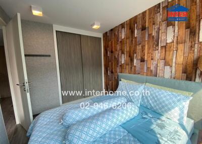 Cozy bedroom with rustic wooden accent wall and modern design