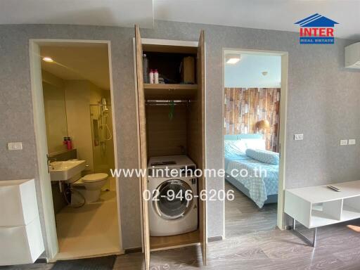Modern bedroom with ensuite bathroom, including visible amenities such as a washing machine