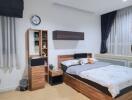 Well-furnished modern bedroom with wooden accents