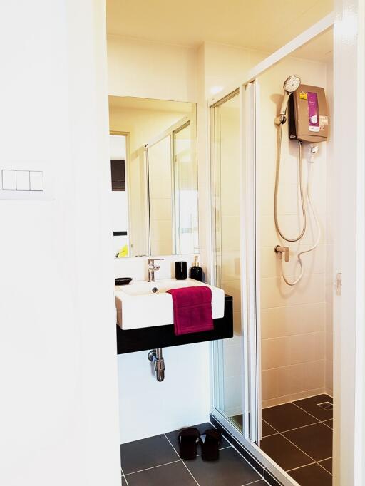 Modern bathroom with shower, glass door, and stylish sink