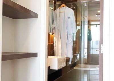 Modern bathroom viewed from hallway with built-in shelves