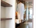 Modern bathroom viewed from hallway with built-in shelves