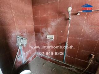 Small bathroom with visible wear and damage on walls