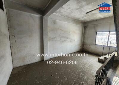 Empty concrete room with large windows and tiled floor
