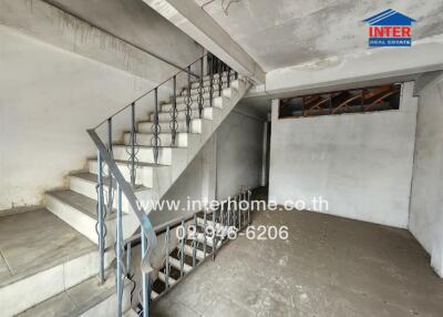 Unfinished concrete staircase inside a building under construction