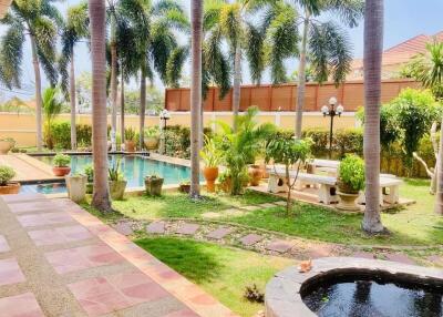 Lush garden with swimming pool and ornamental plants at a residential property