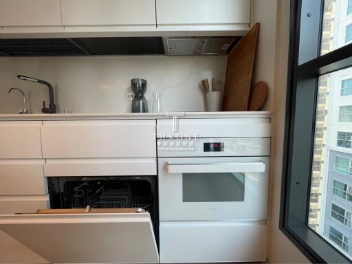 Modern kitchen with dishwasher and high-rise building view