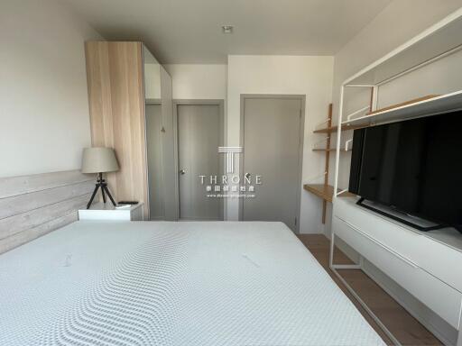 Modern bedroom interior with large bed, wooden wardrobe, and entertainment unit