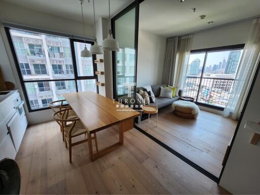 Spacious living room with large dining table and balcony access