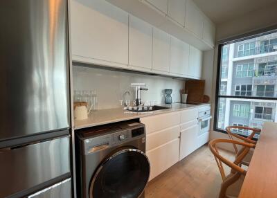 Modern kitchen with integrated appliances and wooden countertop