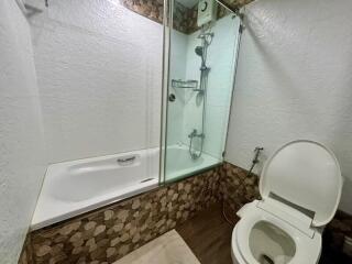 Compact bathroom with enclosed shower and toilet