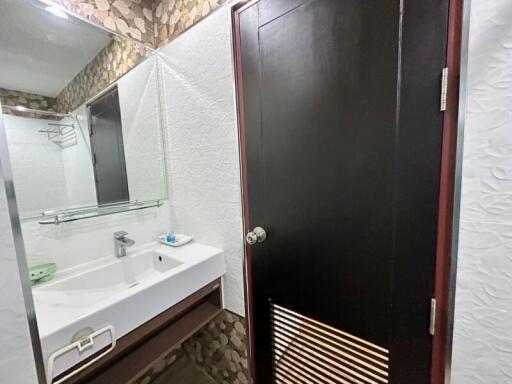 Modern bathroom with textured walls and sleek furnishings