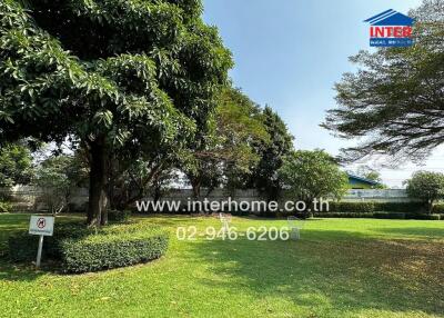 Lush garden with trees in front of a residential building