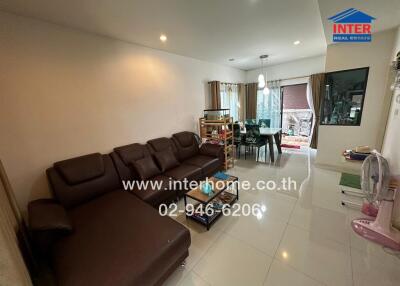 Spacious living room with large sectional sofa and dining area