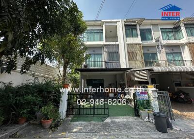 front view of a residential townhouse with visible contact details