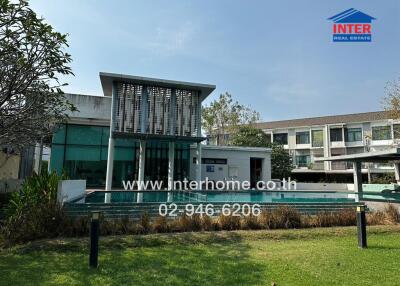 Modern residential building exterior with landscaped front yard