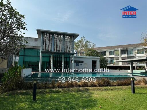 Modern residential building exterior with landscaped front yard