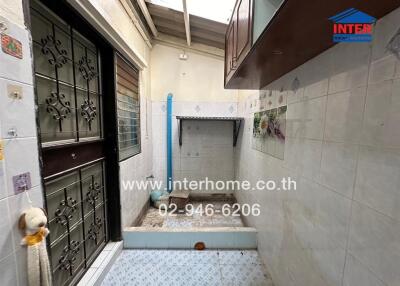 Compact laundry space with washing machine and tiled floor