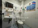 Compact and Fully Tiled Bathroom with Toilet and Sink