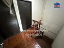 Interior staircase in a home with wooden banisters and tiled flooring