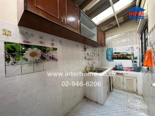 Compact residential kitchen with wooden cabinets and tiled walls