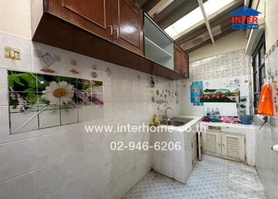 Compact residential kitchen with wooden cabinets and tiled walls
