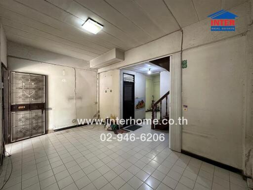 Interior view of a building hallway with tiled floors