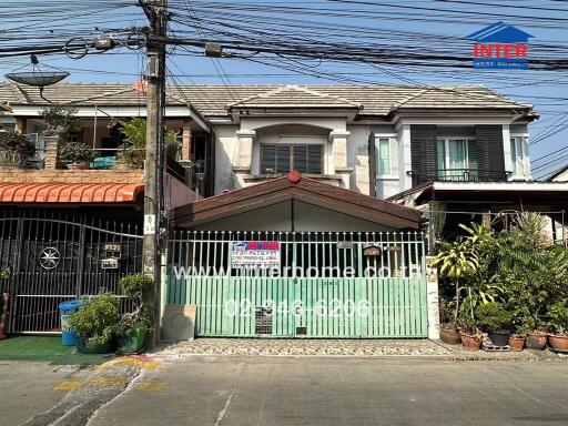 Exterior view of a family home with gated fencing and surrounding neighborhood