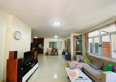 Spacious and well-lit living room with modern furniture and large windows