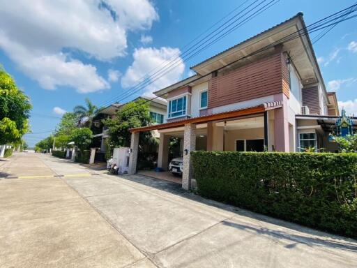 Suburban Residential Home with Carport and Well-Maintained Garden