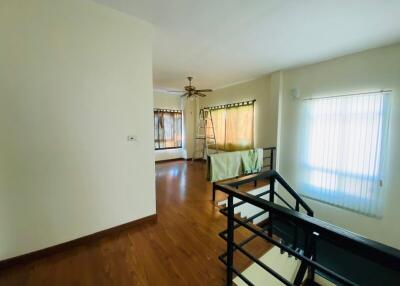 Spacious living room with hardwood floors and natural light