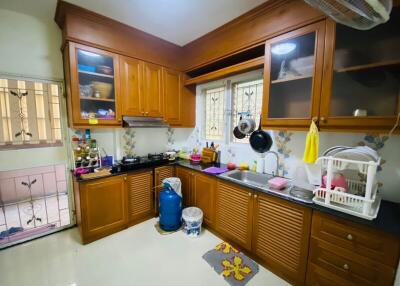 Bright and well-equipped kitchen with wooden cabinets and modern appliances