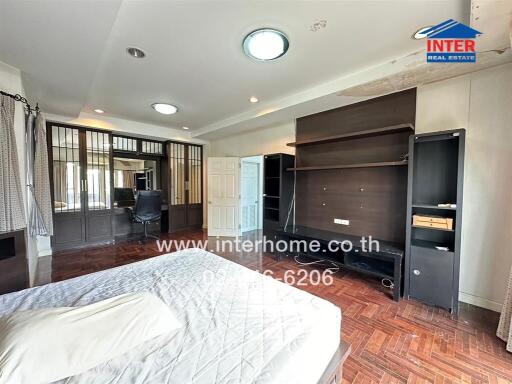 Spacious bedroom with modern furnishings and ample natural light