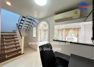 Spacious modern living room with staircase and air conditioning unit