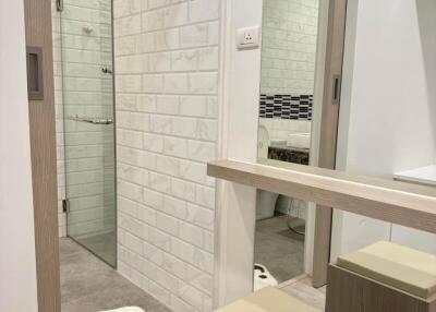 Modern bathroom with glass shower door and stylish tiling