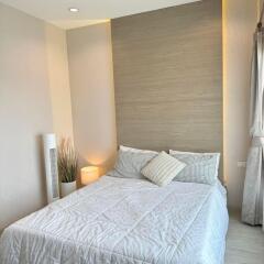 Modern bedroom with neatly arranged bed and calming decor