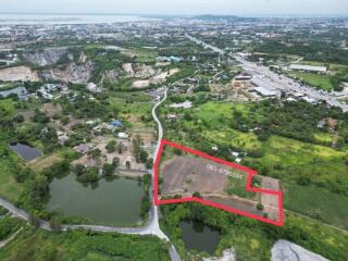Aerial view of a large property lot with marked boundaries near water bodies and roads