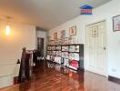 Spacious living room with wooden floors and decorated wall