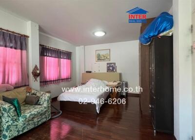 Spacious living room with natural light and comfortable furnishings