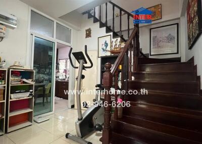 Spacious living area with staircase and fitness equipment