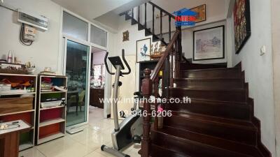 Spacious living area with staircase and fitness equipment