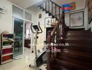 Spacious living area with staircase and fitness equipment