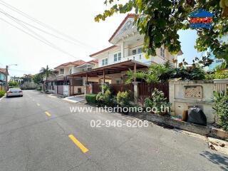 Residential street view with terraced houses and parked cars