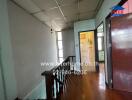 Spacious hallway with wooden flooring and natural lighting