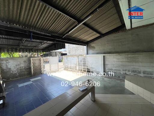 Spacious covered garage with tiled flooring and ample natural light